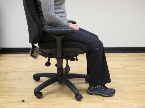 How to Sit Properly At Your Desk 4 woman sitting in chair with feet flat on the floor